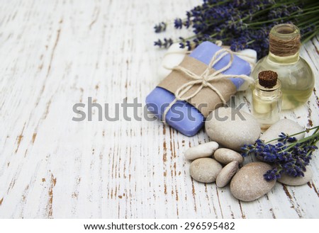 Spa products and lavender flowers on a old wooden background