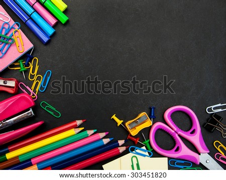 school supplies on a school   black board
