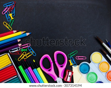 school supplies on a school   black board