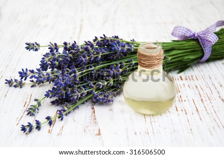 Lavender,and massage oil  on a old wooden background