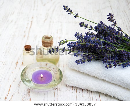 Lavender and massage oils on a old wooden background