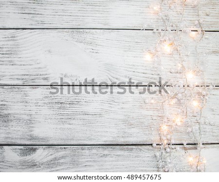 christmas garland lights on wooden rustic background