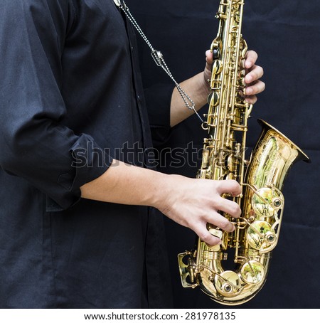 CHIANGMAI, THAILAND - MAY 28, 2015.  image of a young man  playing  alto saxophone made  in France by selmer company at In  Grace Church Chiangmai, Thailand