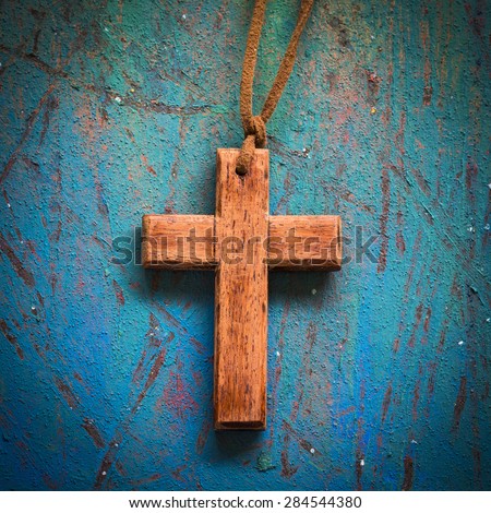 wooden cross on blue retro painted  background