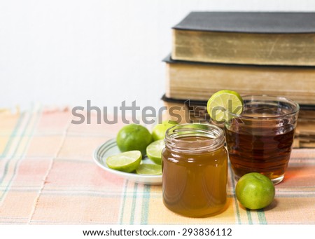 Freshly cut half and whole lemon with a cup of tea with the books of Holy Bibles on the table