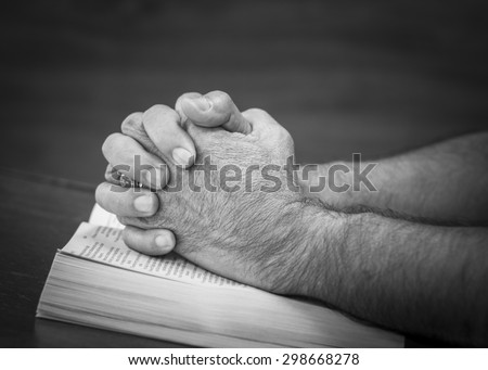 CHIANGMAI, THAILAND - July 22, 2015. Praying hands of a man on the open  bible (New International  Version) christian believe that  the bible is the word of God and try to reading the bible everyday.