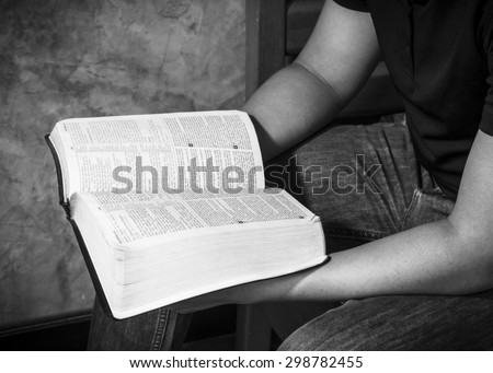 CHIANGMAI, THAILAND - July 22, 2015. A man hands holding  the open  bible (New International  Version) christian believe that  the bible is the word of God and  try to reading the bible everyday.