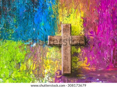 The wooden christian cross on colorful  oil painted background