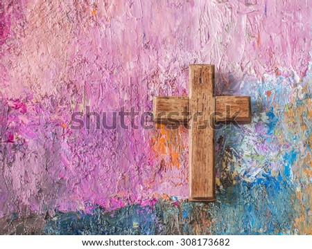 The wooden christian cross on colorful  oil painted background