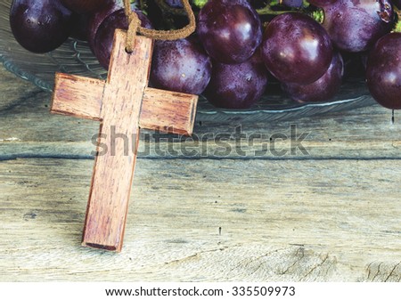 Wooden cross and grape on wooden background, christian symbol Jesus is the true vine from bible verses John 15:1