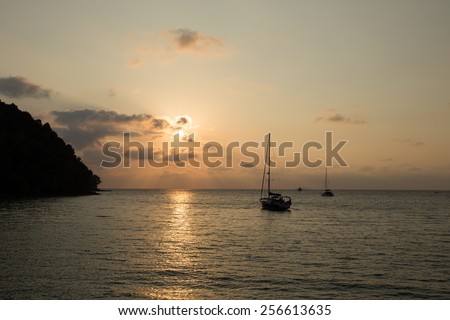 The Sailboat in the middle of the ocean on the sunset time