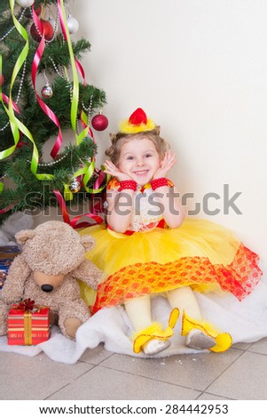 Funny girl in a chicken suit sitting near eloski with a bear and a gift
