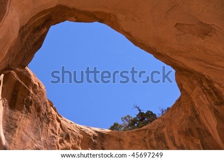 Bowtie Arch, a pothole arch formed when a pothole broke through from the top of the cliff. Corona Arch Trail, Moab, just outside Arches National Park.