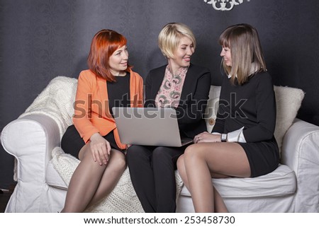 Woman in the office. Three business women office employee met at a business lunch. Informal setting for a business meeting. Girlfriend had meetings to discuss new plans for the holiday.