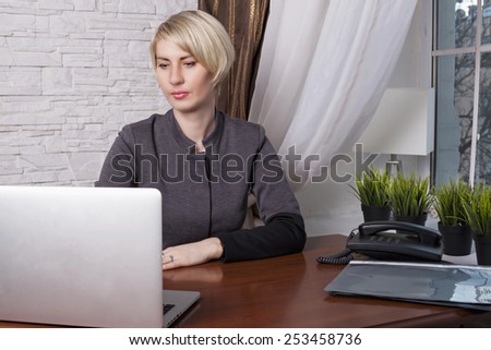 Business woman at work. Woman in the office. business woman working at a computer, laptop in the office on the desk