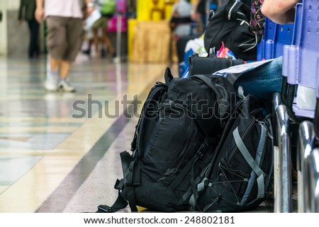 Backpack and passengers waiting in the station