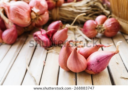 heap of onions on bamboo floor