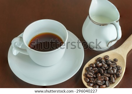good smell with hot coffee and coffee bean on the table, fresh coffee served with milk cup