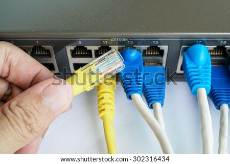 hand hold network cable to connect to switch hub