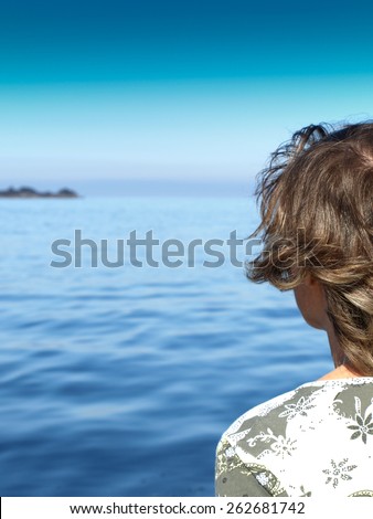 Woman looking at the distant horizon, Dingle peninsula, Ireland