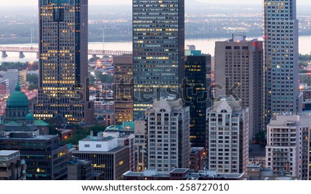 Montreal office buildings, and the church to the left of the image with a little digital noise at dusk.