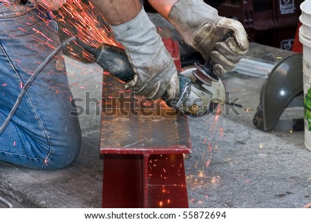 Man hands cutting metal beam,with electric cutter