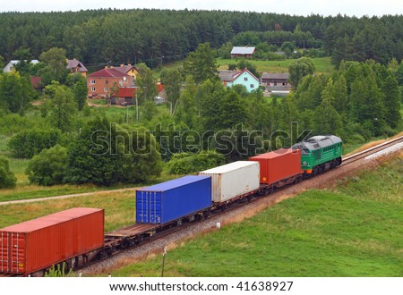 Rural landscape with the container train passing through countryside