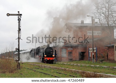 Old retro steam train stopped at the small station