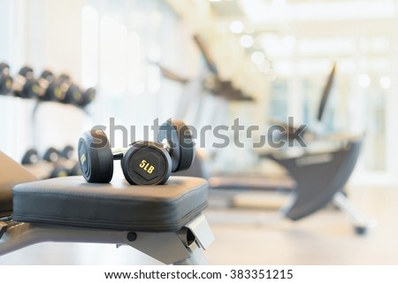 Two dumbbells on the exercise bench. Gym equipment.