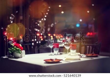 Romantic dinner setup or Holiday table setting, red decoration with candle light.