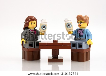 Colorado, USA - June 11, 2015: Studio shot of custom Lego minifigure women sitting at a table drinking Brickbucks coffee.