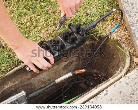 Hobart, Australia - 2015, April 11: Installation of a customer connection drop cable into a Multiport at a pit used for the installation of the National Broadband Network in Australia.