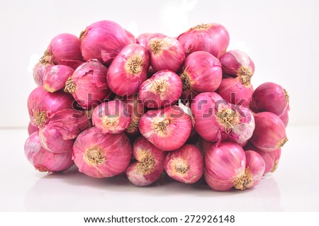 bunch of small thai red onions on white background