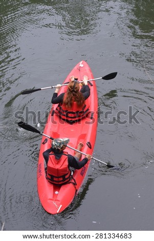 Couple riding canoe in river