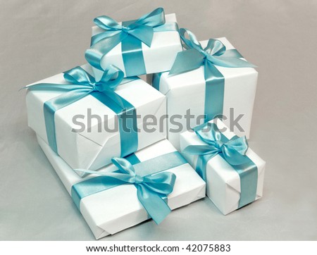 Cute white gift boxes with blue ribbon