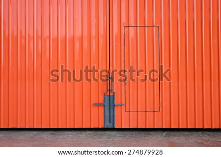 Orange metal sheet factory gate.