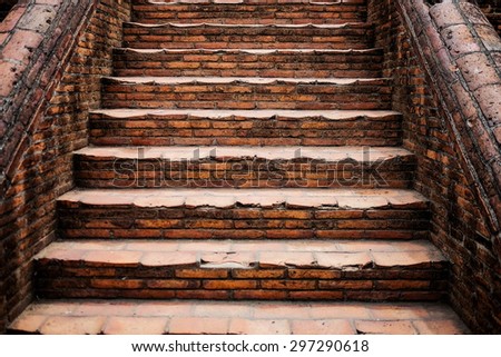 The old grunge staircase made from red brick , processed in grunge tone.