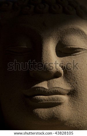 sand stone buddha\'s face from close up