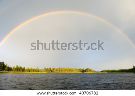 Rainbow over the lake after the rain