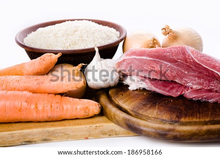 carrots, meat, onions and rice- ingredients for pilaf