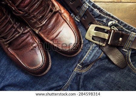 Jeans belt and shoed set on wood