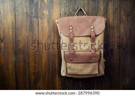 Canvas and leather backpack on wood