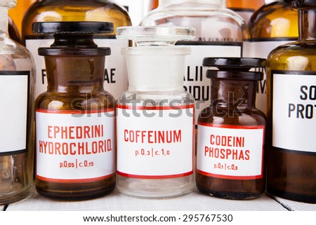 Bottle with caffeine among other vintage medicine bottles