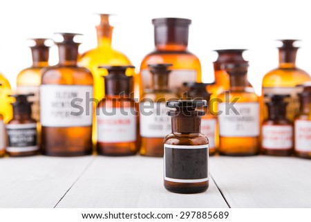 medicine bottle with blank label on wooden table