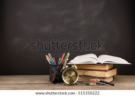 Education concept - books on the desk in the auditorium