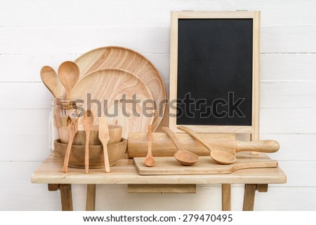 Still life with wood utensils and black board on wood table