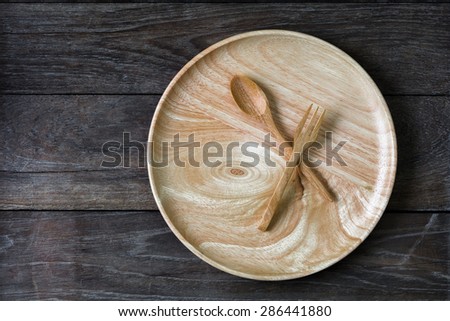 Wood spoons and wood dish on wood board  background
