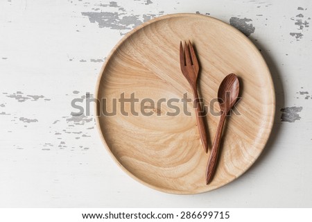 Wood spoons and wood dish on wood board  background