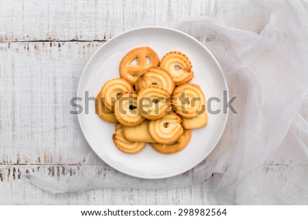 Danish butter Cookies in white ceramic dish on wood board