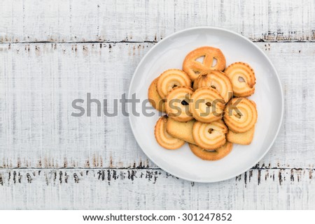 Danish butter Cookies in white ceramic dish on wood table